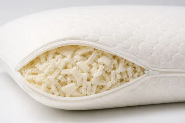My Honest Saatva Pillow Review (After 60 Nights of Real Sleep Testing) 6 Close-up of Saatva pillow showing shredded Talalay latex core inside microfiber layer