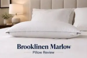 Brooklinen Marlow pillow with dual side zippers for adjustable firmness on white bedding showing cotton sateen cover