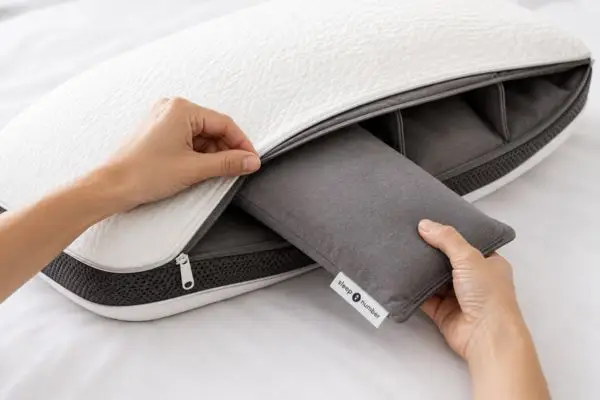 Installing insert into Sleep Number ComfortFit Pillow Ultimate pocket showing clean, mess-free adjustability